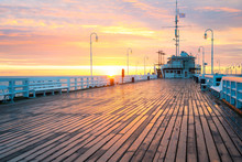 The First Rays Of The Sun Warms The Wet Boards Of The Pier In Sopot. Poland.
