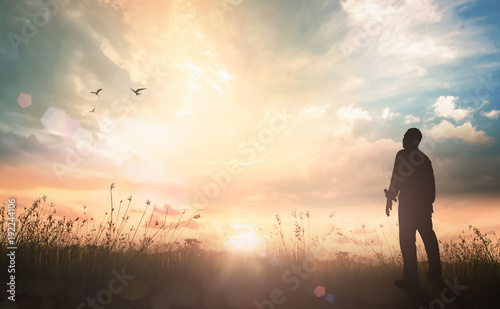 Fotografía World mental health day concept: Silhouette of human standing to worship God in