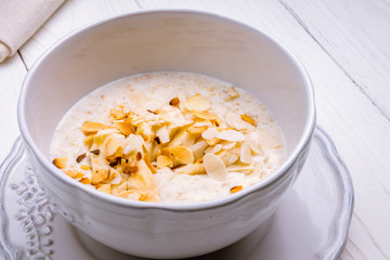 Wall Mural - Oatmeal porridge with banana and almonds