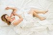 © LIGHTFIELD STUDIOS - top view of charming woman sleeping in bed at home