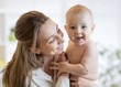 © Oksana Kuzmina - Happy family laughing faces, mom holding cute child baby boy. Young woman and small son smiling and hugging.