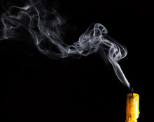 Yellow Candle With White Smoke On Black Background