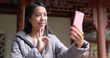 Wall Mural - Woman making live stream on cellphone in china