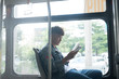 © makistock - Public transport. people in the bus. Asian man sitting inside city bus.