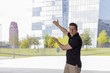 © Nektarstock - Man Pointing at Skyscraper Buildings