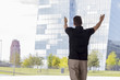 © Nektarstock - Man Pointing at Skyscraper Buildings Rear View