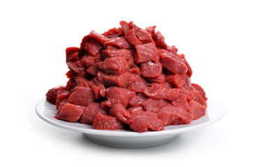 Cuts of raw beef meat on a plate isolated on white background.