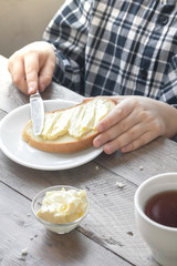 Wall Mural - hands spreading butter on bread