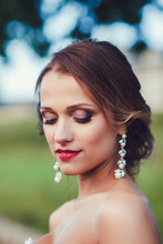 Happy Beautiful Bride With Hairstyle And Artistic Smoky Eyeshadow And Smiling On Bokeh Background.