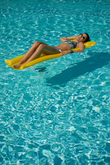 Wall Mural - Woman relaxing in a pool