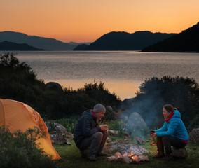 Wall Mural - couple camping with campfire and tent outdoors