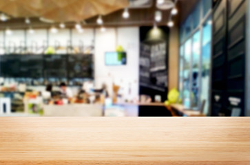 Wall Mural - Selected focus empty brown wooden table and Coffee shop or restaurant blur background with bokeh image. for your photomontage or product display.