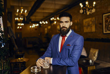 Portrait Of Elegant Young Man In A Bar With Tumbler