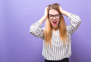 Wall Mural - Young woman feeling stressed on a solid background