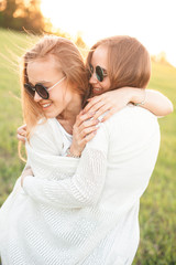 Wall Mural - Two best friends hugging outdoors