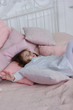 © sharafmaksumov - Little kid girl sleeping in a pink bed at home and watching dreams.