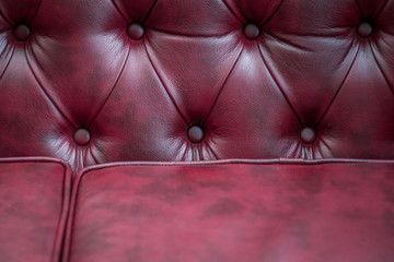 Closeup texture of vintage red leather sofa for background