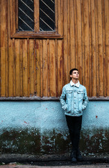 Wall Mural - pensive guy on the background of an wooden wall