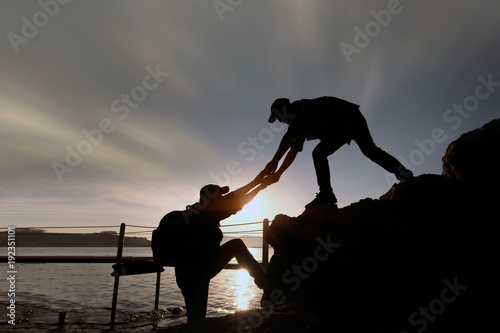 Man Climbing Up On The Mountain Hiking And Team Work Concept