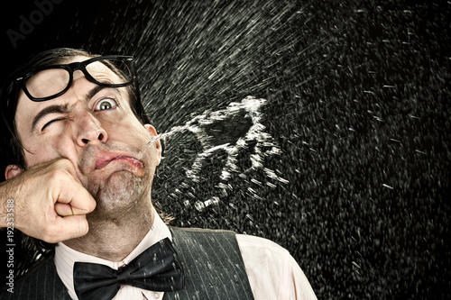 Fotomural elegant nerd with glasses hit by punch on black background