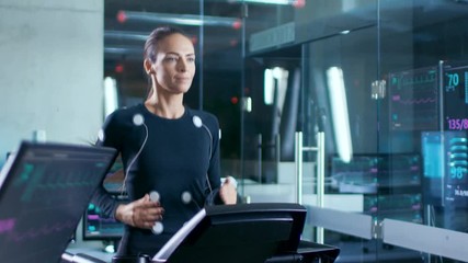 Wall Mural - in scientific sports laboratory beautiful woman athlete runs on a treadmill with electrodes attached