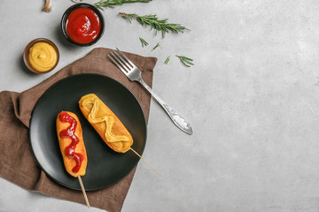 Wall Mural - Tasty corn dogs with sauces on plate