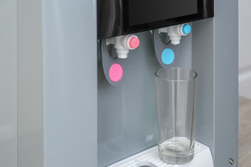 Wall Mural - Office water cooler with glass, closeup