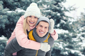 Canvas Print - Happy loving couple having fun in winter park