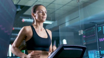 Wall Mural - in scientific sports laboratory beautiful woman athlete walks on a treadmill with electrodes attache