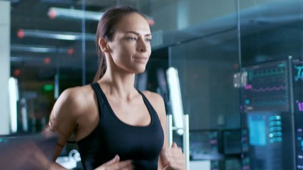 Wall Mural - in scientific sports laboratory beautiful woman athlete walks on a treadmill with electrodes attache