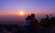 Brother And Sister Sitting On Rock And See Sunset Together At Sunset View Point Background At Phu Hin Rong Kla National Park Phitsanulok Province, Thailand, Love Concept