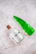 Bottles with coconut oil and aloe vera gel on gray concrete background. Body and skincare spa essentials, after sun skin treatments. Beauty blogging minimalism concept