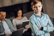 © zinkevych - Wanna be loved. Upset pre-teen boy pouting, being disappointed by the lack of his parents attention while the parents sitting on the couch and being glued to their laptops
