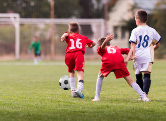 Young children players football match on soccer field