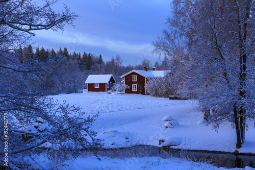 House By Bare Trees During Winter In Stocka Sweden