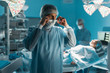 © LIGHTFIELD STUDIOS - surgeon wearing medical mask in operating room