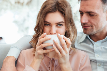 Poster - Portrait of a cheerful young couple drinking coffee