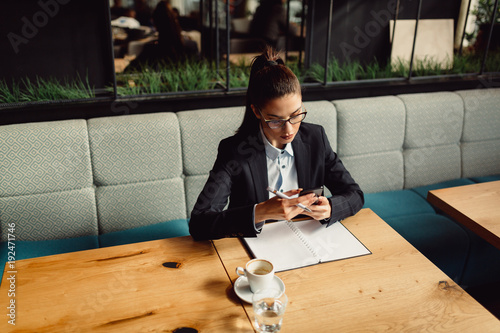 Portrait of young businesswoman in cafeteria. Poster