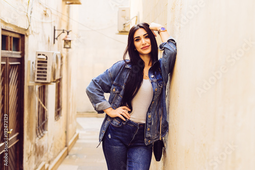 Attractive Black Haired Girl In A Jeans Jacket Travels Through