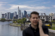 © Nektarstock - Selective Focus of Man Talking on Mobile Phone and City Skyline