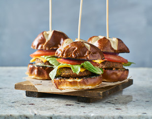 Wall Mural - three vegan burger sliders with pretzel buns