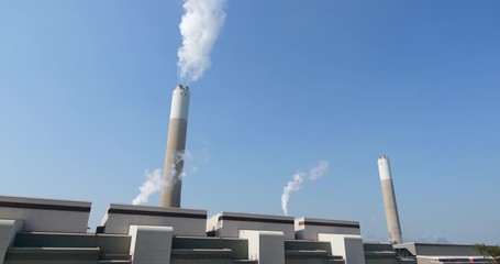 Wall Mural - Factory with Smoke stack over blue sky