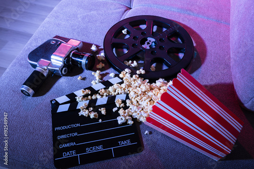 Fotografering Spilled Popcorn With Clapperboard And Movie Camera