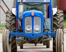 Vintage Blue Tractor Head Shot. Headlights And Grill.