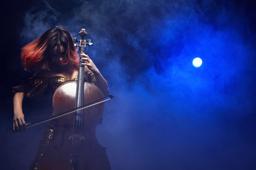 The cellist girl performs on stage.