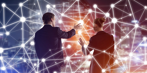 concept of social connection and networking against night city view and partners working in cooperat