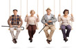 Cheerful seniors sitting on wooden swings and looking at the camera