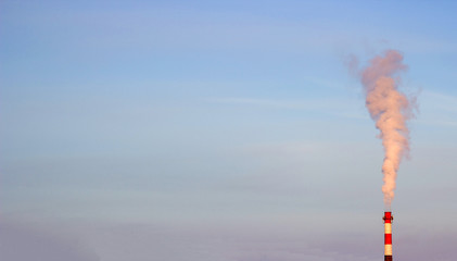 industrial smoke from chimney on blue sky