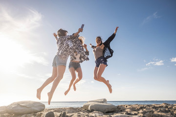 Three young woman jump for happiness. beauty and fun.