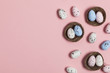 © ink drop - Easter eggs in a nest on a pastel pink background